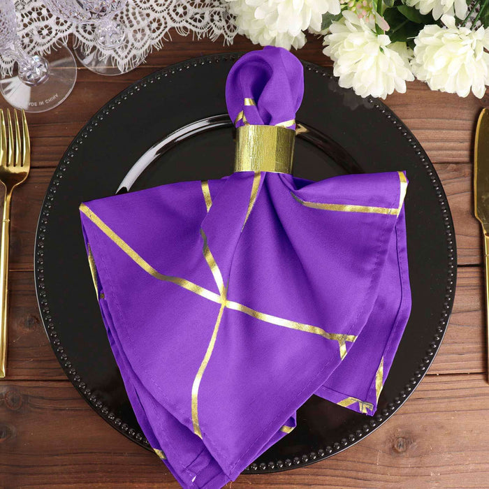 Purple napkin with gold accents elegantly styled on a black plate.
