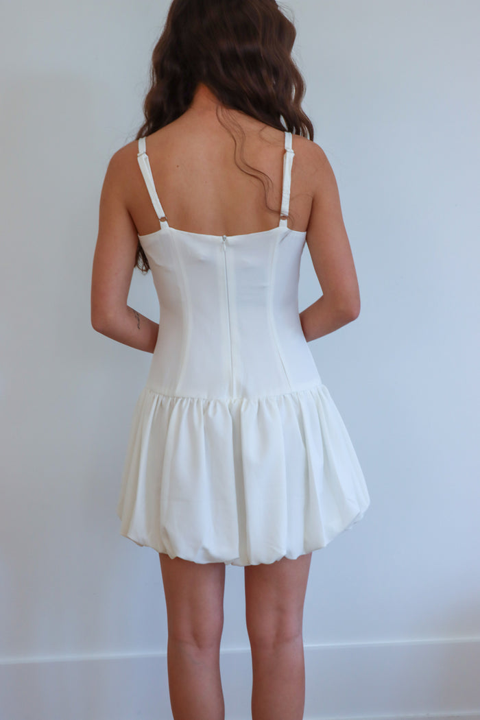 girl wearing white short drop waist bubble dress