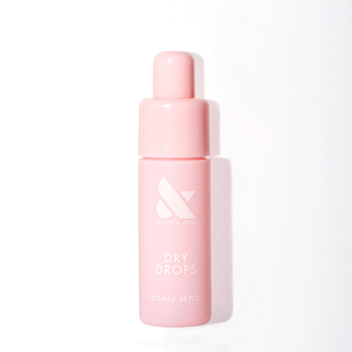 Pink bottle of Olive and June Dry Drops with dropper cap for fast drying mani and polish care at home