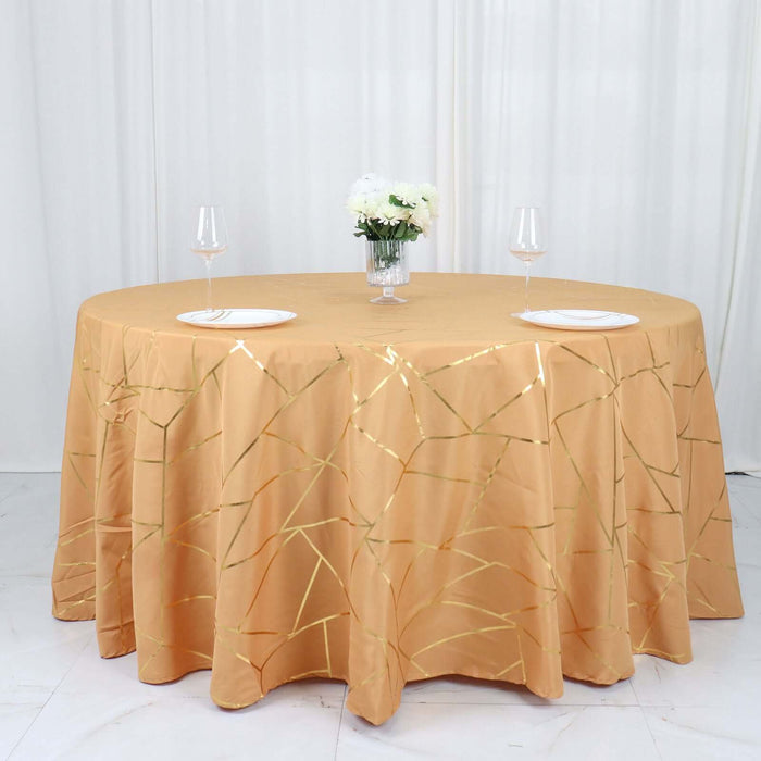 Gold crackle tablecloth on a round table with wine glasses and plates.