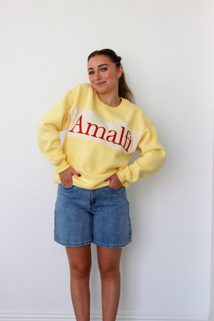 girl wearing yellow "amalfi" crewneck