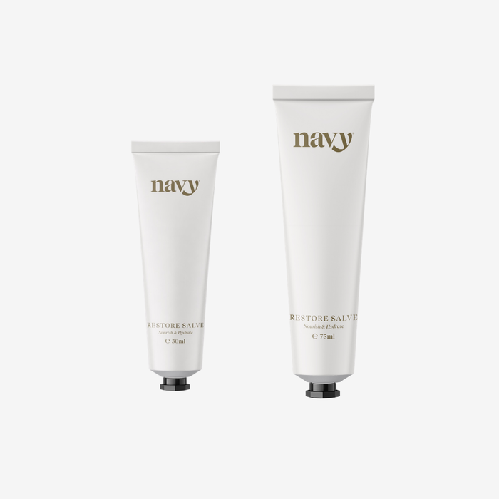 Two tubes of 'navy' Restore Salve on a white background