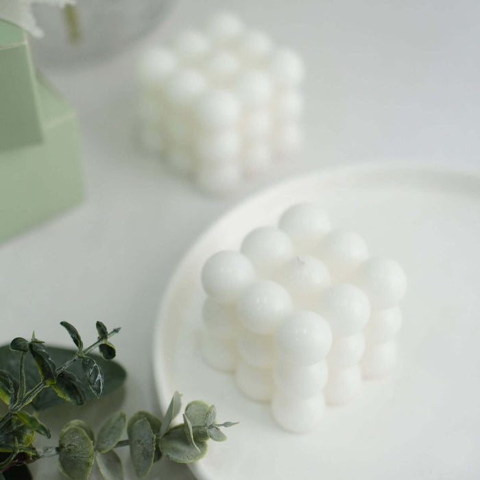 White decorative bubble-shaped object on a plate with greenery.