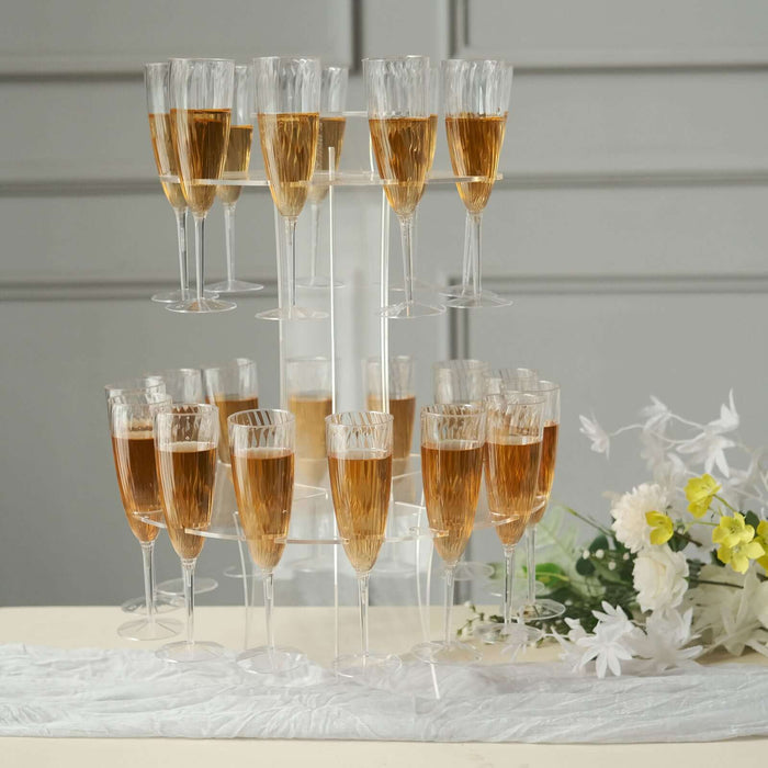 Champagne flutes arranged in a tiered display with sparkling beverage.