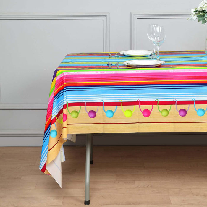 Colorful striped tablecloth with decorative circles, styled on a table setting.