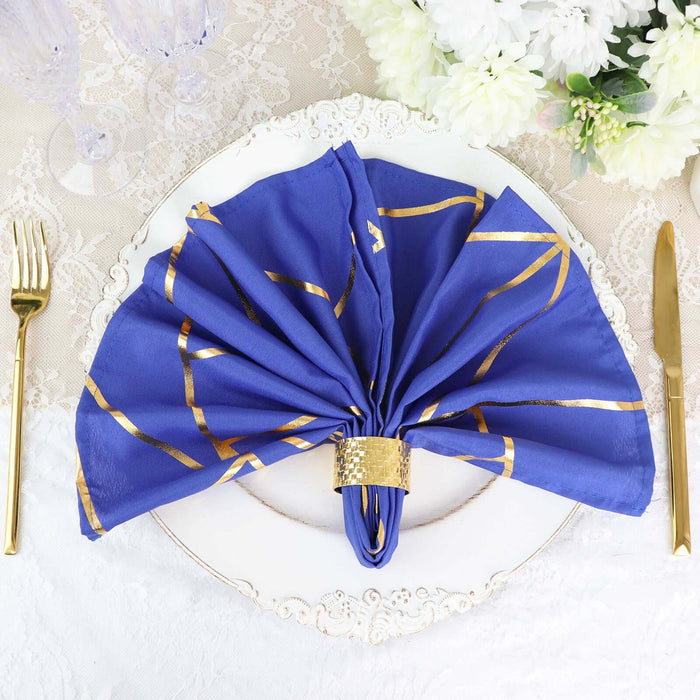 Elegant blue napkin with gold stripes, elegantly arranged on a decorative plate.