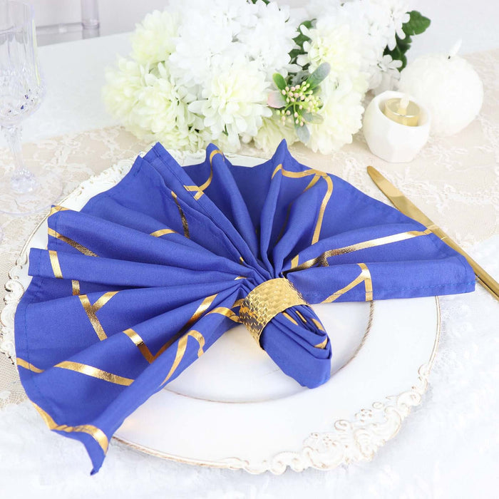 Elegant blue and gold table napkin elegantly arranged on a decorative plate.