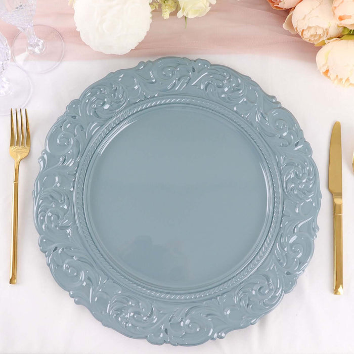 Elegant blue decorative plate with ornate design on a table setting.