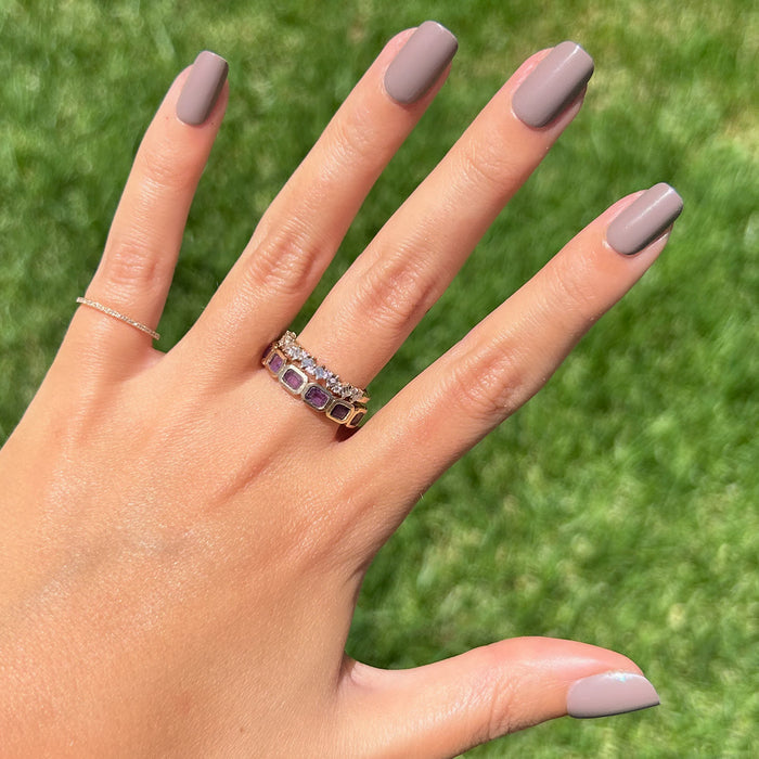 AW - Press-On | Short | Squoval showing hand with warm grey short squoval press-on manicure outdoors on grass background