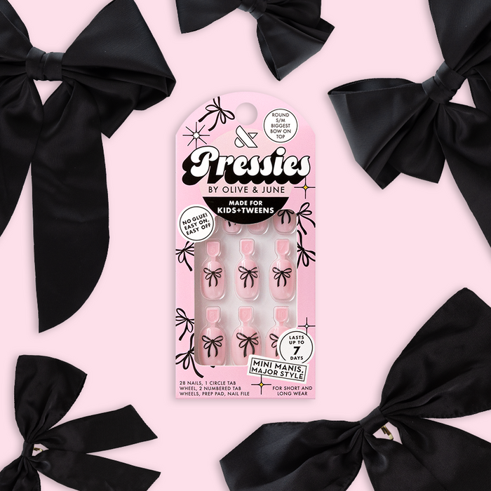 Biggest Bow On Top - Pressies | Short Medium | Round showing light lavender press-on nails with black bow design by Olive and June