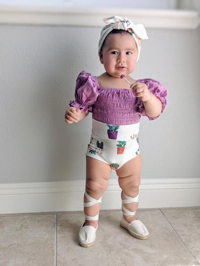 Adorable baby girl bummies with watercolor cactus pot print, great for summer wear.
