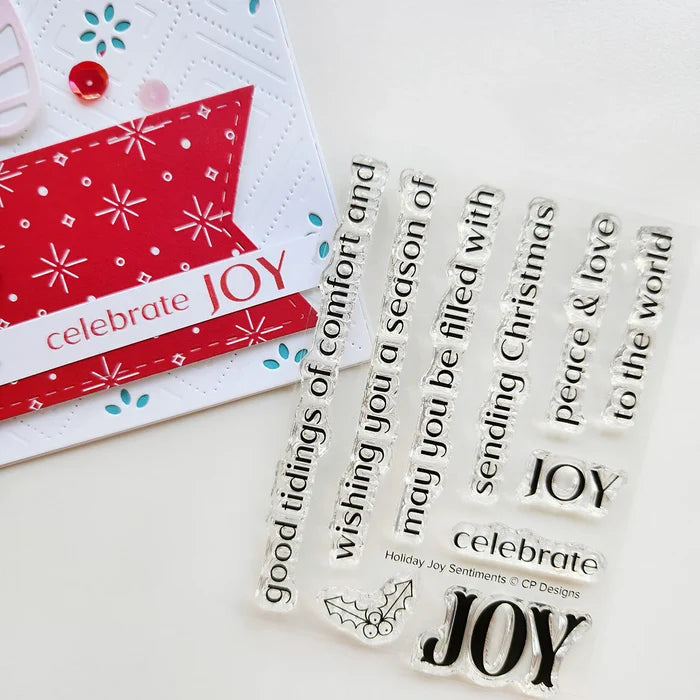 Catherine Pooler - Sentiment Stamps - Holiday Joy. Designed to pair beautifully with the Festive Joy Word Die, it’s ideal for sending peace, love, and joy this season. Make your festive messages shine with this essential sentiment set! Available at Embellish Away located in Bowmanville Ontario Canada.