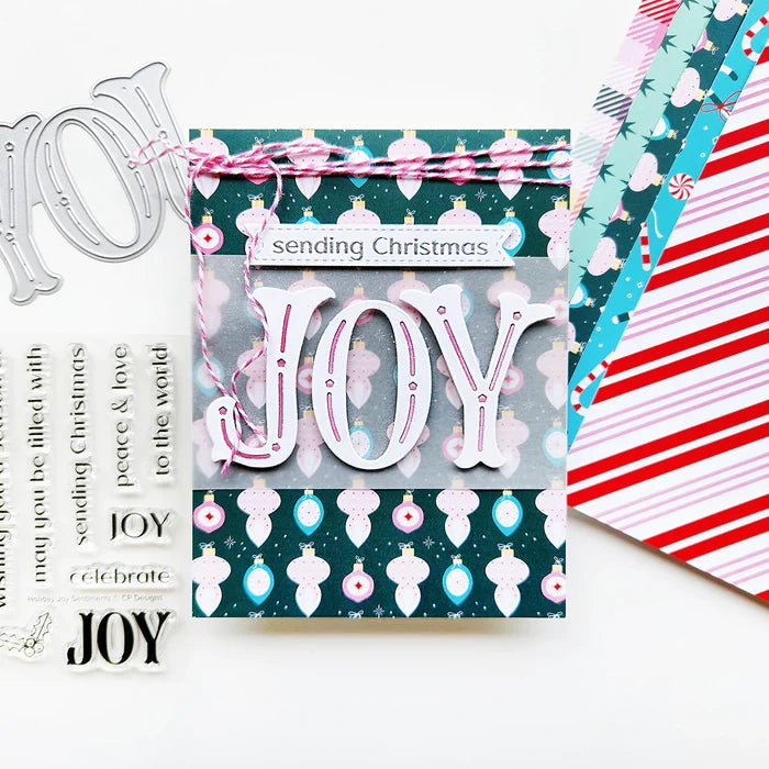 Catherine Pooler - Sentiment Stamps - Holiday Joy. Designed to pair beautifully with the Festive Joy Word Die, it’s ideal for sending peace, love, and joy this season. Make your festive messages shine with this essential sentiment set! Available at Embellish Away located in Bowmanville Ontario Canada. Example by Catherine Pooler Designs.