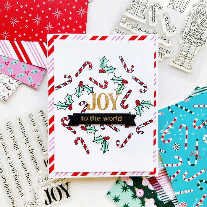 Catherine Pooler - Sentiment Stamps - Holiday Joy. Designed to pair beautifully with the Festive Joy Word Die, it’s ideal for sending peace, love, and joy this season. Make your festive messages shine with this essential sentiment set! Available at Embellish Away located in Bowmanville Ontario Canada. Example by Catherine Pooler Designs.
