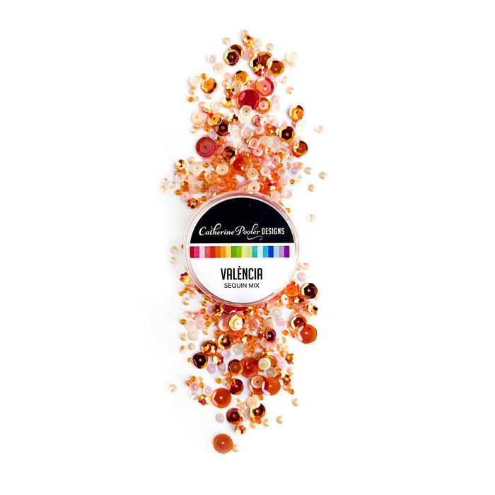 Catherine Pooler - Sequin Mix - Valencia. Add some sparkle in shades of orange with the Valéncia Sequin Mix!  This mix was named for Valéncia, Spain and is bright and cheerful.  This monochromatic mix   and looks great with our Potted Patterned Paper!  Approximately 1 Tablespoon mixture packaged in a clear screw top round container. Available at Embellish Away located in Bowmanville Ontario Canada.
