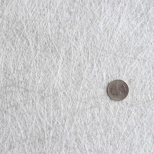 4" width chopped strand mat. Close up of fiberglass mat with short strands of fiberglass held together by a styrene binder.