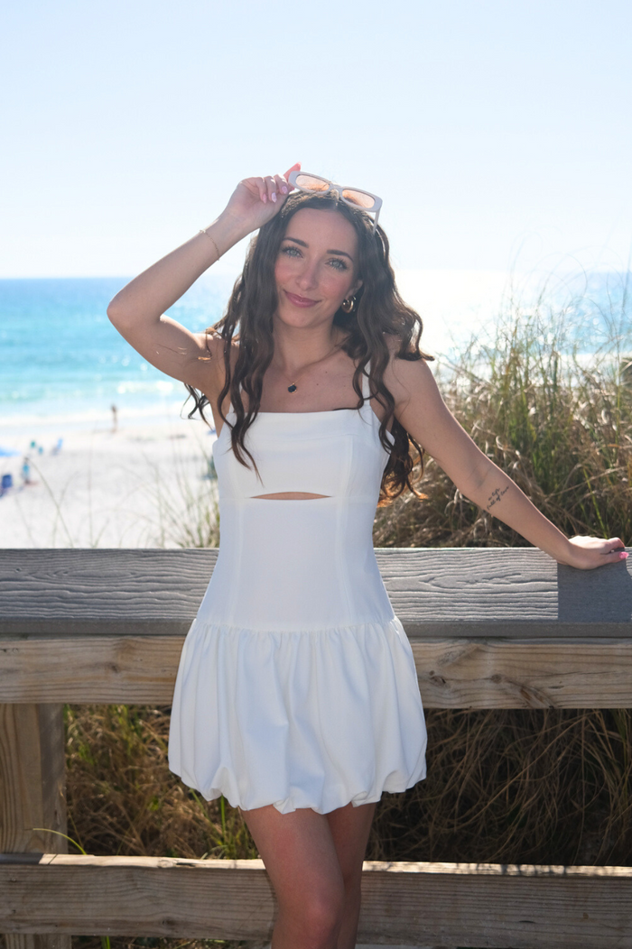 girl wearing white short drop waist bubble dress