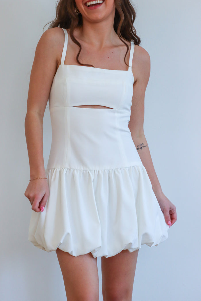 girl wearing white short drop waist bubble dress