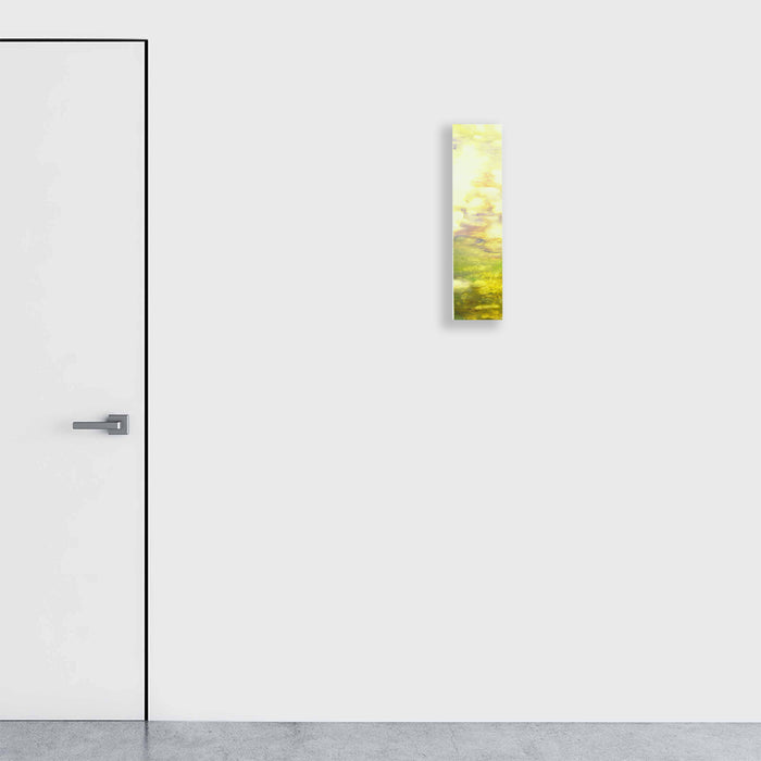 The artwork 'Colored Leaves III' by Takashi Harada features a vertical composition on Kozo Washi paper displaying ethereal yellow and green hues blending seamlessly, reminiscent of sunlit foliage. The acrylic gesso and cray pastel technique creates a luminous, layered effect on the 24x8 inch stretched panel, capturing the delicate interplay of natural light and organic forms. By Takashi Harada.