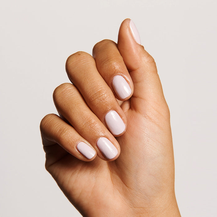 Hand with soft pink manicure showcasing smooth nails, ideal for nourishing with Cuticle Serum Duo for healthy cuticles