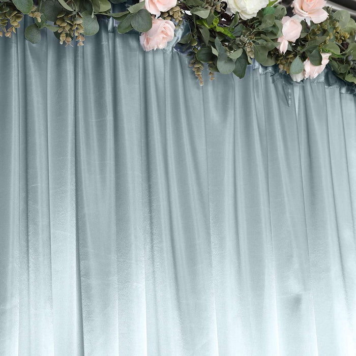 Soft blue velvet curtain with floral garland detail.