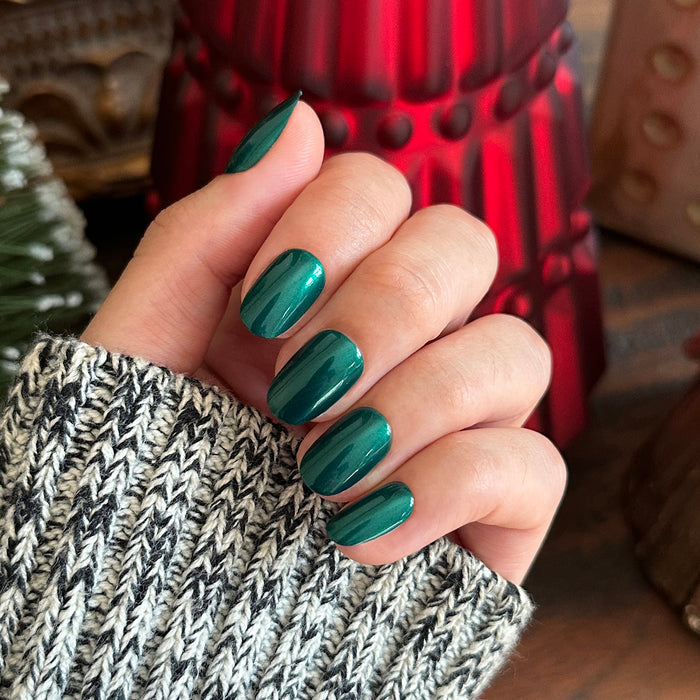 Emerald Velvet - Press-On | Medium | Almond showing glossy deep emerald green false nails on hand with sweater sleeve