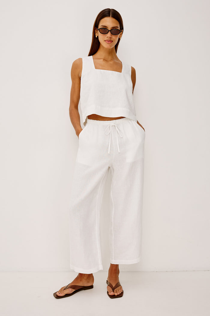 Emmie Crop Pant in Linen With Straight Legs, Adjustable Drawstring Waist Ties, and Side Pockets in White Linen Colorway - Full Body Front View Featured on Model