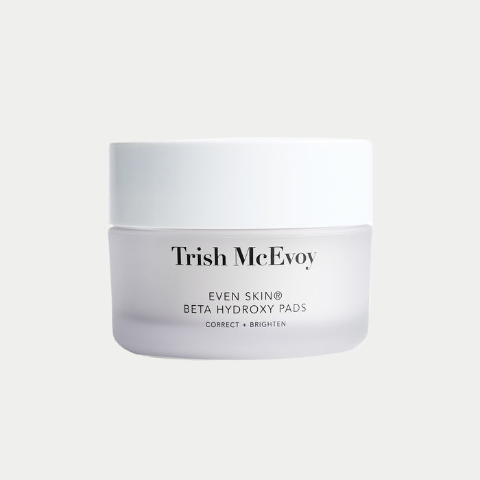 Trish McEvoy Even Skin Beta Hydroxy Pads jar in a white and frosted glass container, centered on a light gray background.