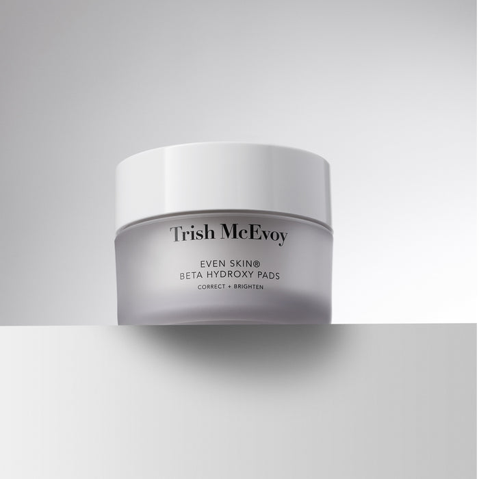 A white cosmetic jar of Trish McEvoy Even Skin Beta Hydroxy Pads, shown on a clean light gray background with a horizontal shadow line.