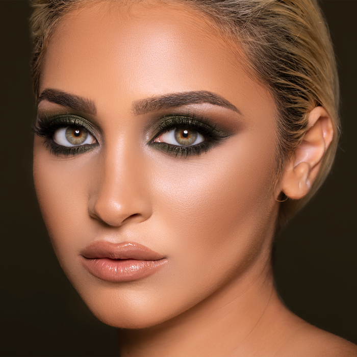 Model wearing Flirty Goddess eyeshadow palette in a smoky bronze look