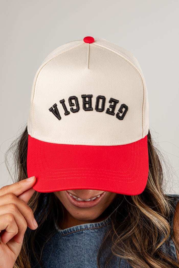 Person wearing a cap with 'Georgia' printed on it against a neutral background