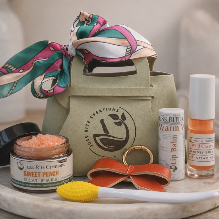 Collection of beauty products including a lip balm, lip scrub, and other items on a marble surface with a branded bag.