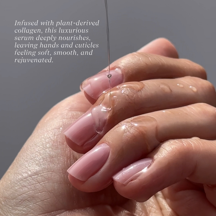 Hand with pink nail polish holding a droplet of serum