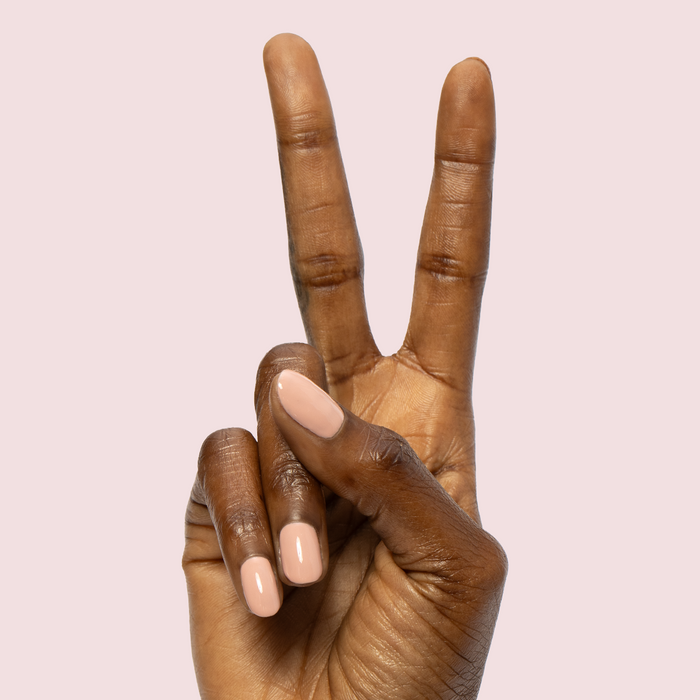 HZ - Gel neutral rosy gel polish manicure on medium-length natural nails against soft pink background