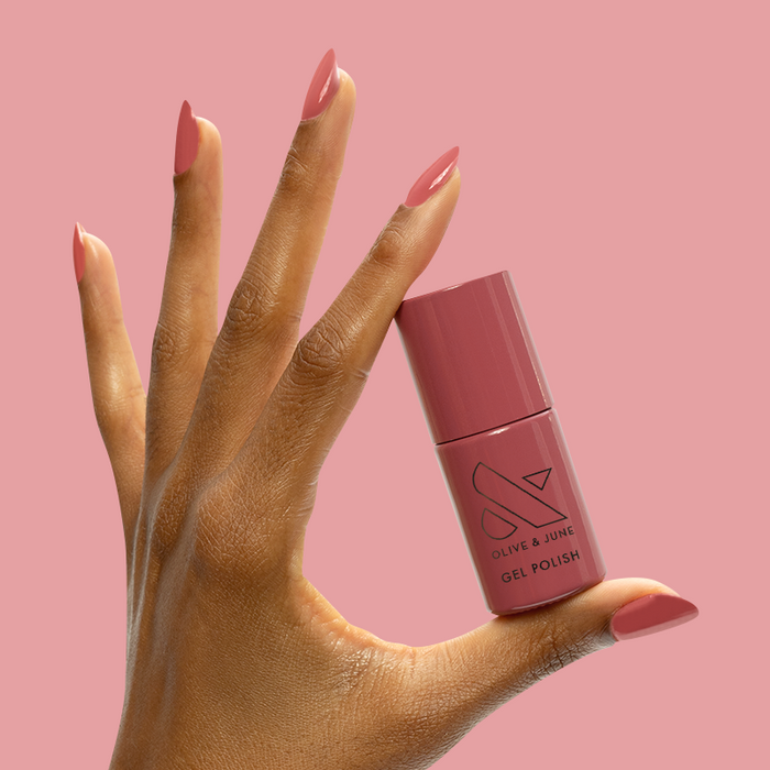 LD - Gel bottle held by hand with matching rosy mauve gel polish for a smooth, long-lasting manicure by Olive and June
