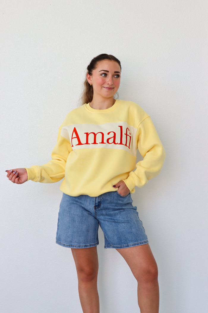 girl wearing yellow "amalfi" crewneck