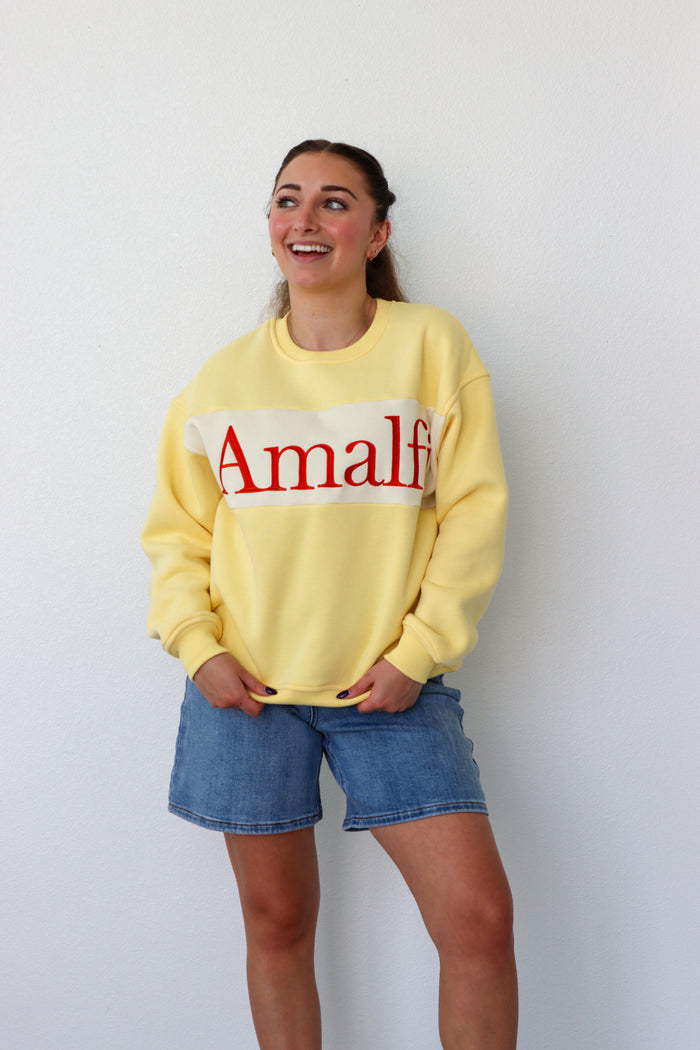 girl wearing yellow "amalfi" crewneck