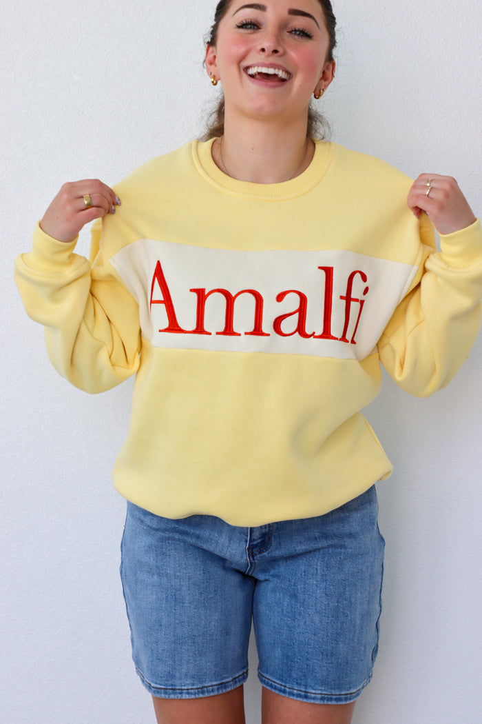 girl wearing yellow "amalfi" crewneck