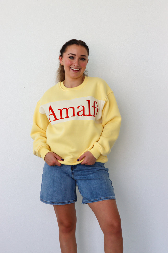 girl wearing yellow "amalfi" crewneck