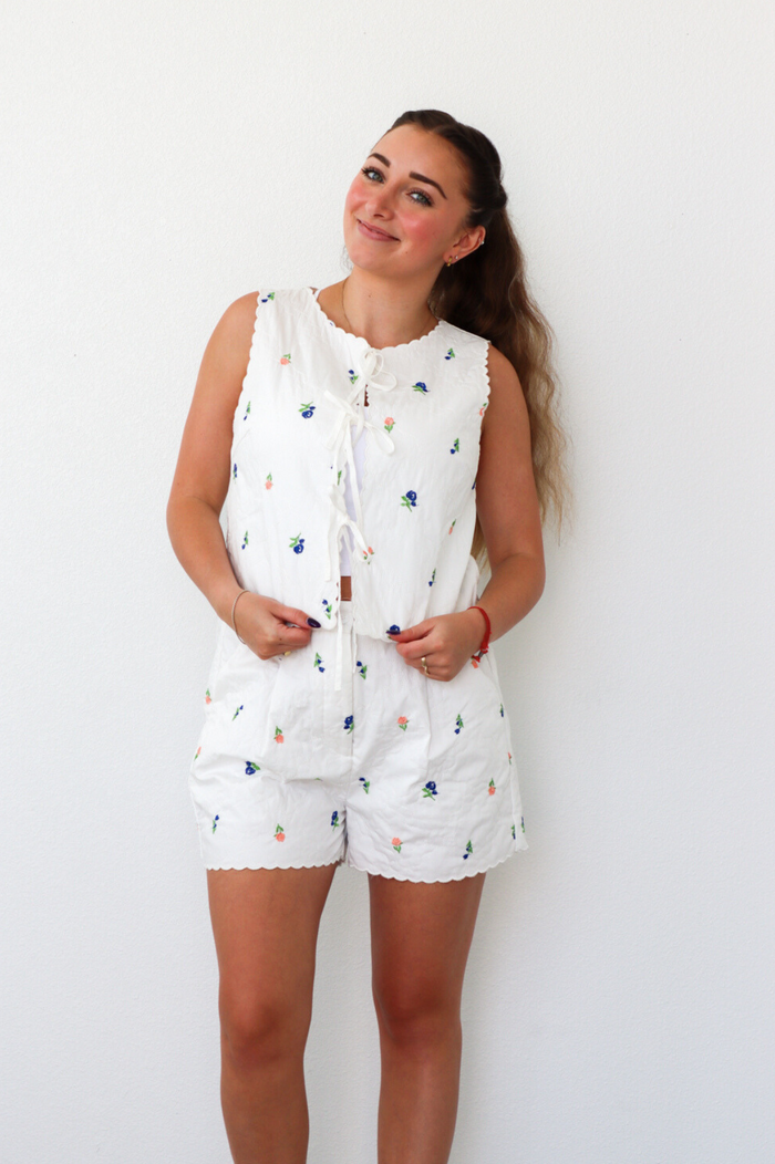girl wearing white quilted floral matching set