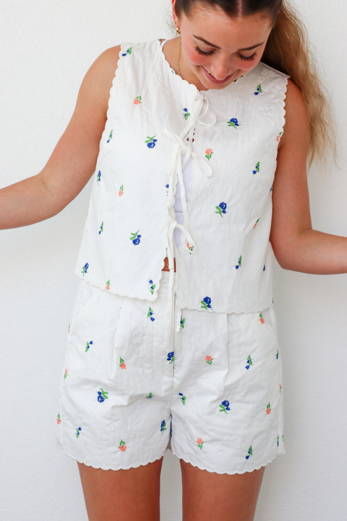 girl wearing white quilted floral matching set