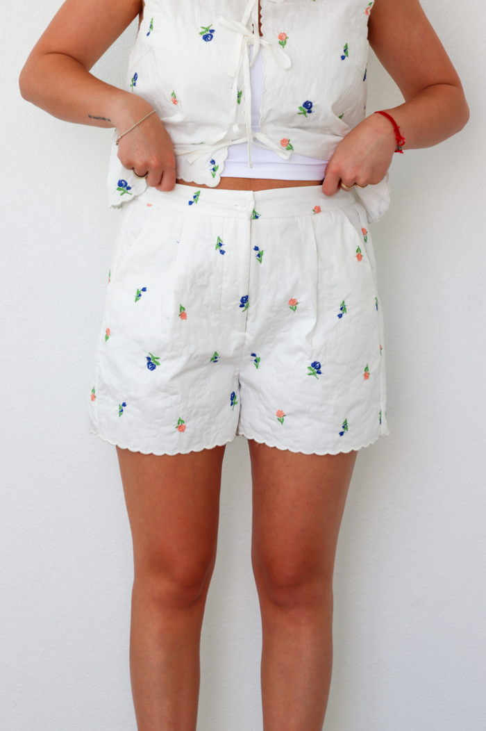 girl wearing white quilted floral matching set