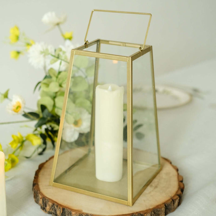 Glass lantern with white candle, surrounded by flowers on a wooden slice.