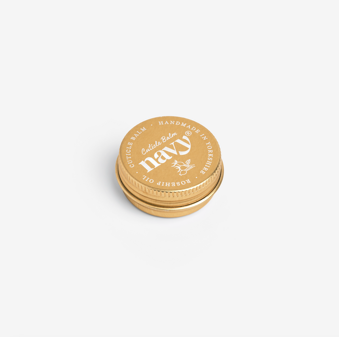 A 15ml tin Navy Cuticle Balm with a gold-coloured label and lid, on a white background.