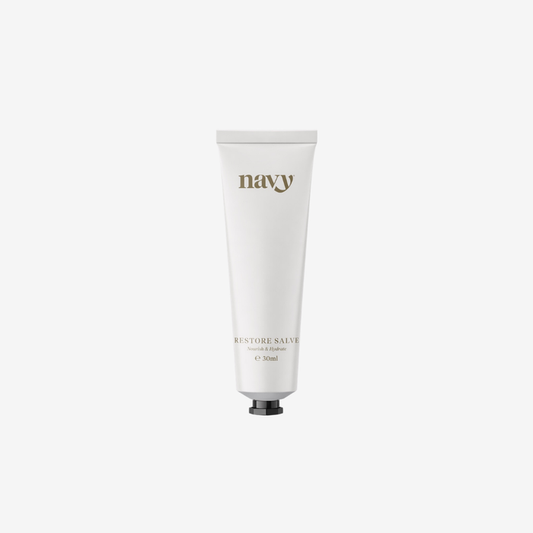 White tube of 'navy' balm on a white background