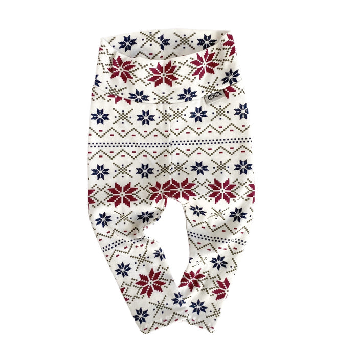 Handmade baby leggings with festive Nordic snowflake pattern in red, navy, and cream. Perfect for cozy winter outfits and holiday photos.