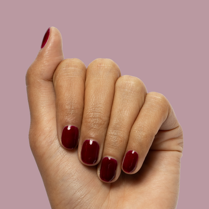 Obsessed - Gel shown on nails in a deep ruby red shade for a glossy, long-lasting gel manicure by Olive and June
