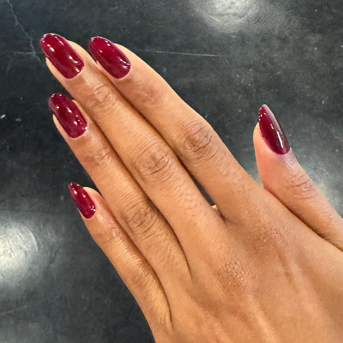 Obsessed - Gel shown on natural nails in a deep dark ruby shade for a glossy, rich gel polish manicure by Olive and June