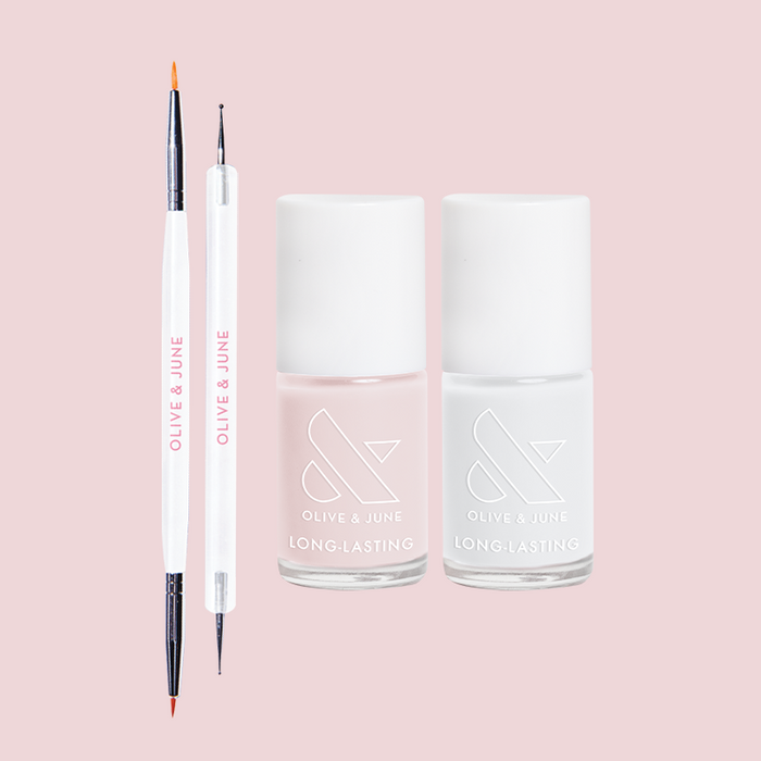 Polka Dot Mani Polish Set featuring two long-lasting nail polishes and dual-ended nail art tools on pink background