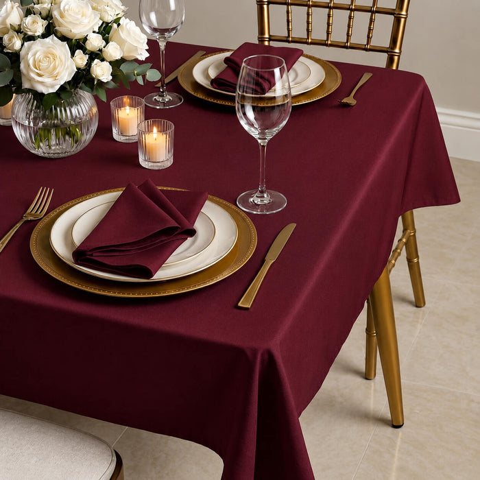 Burgundy linen texture tablecloth on a dining table setting.